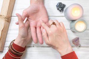 Fortune teller reading future by the hand. Palmistry.