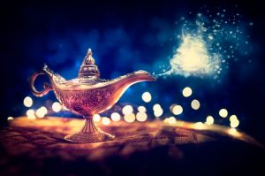 Magic lamp from the story of Aladdin with Genie appearing in blue smoke concept for wishing, luck and magic